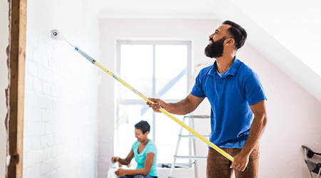 Couple painting new house